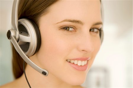 Portrait of a young woman, listening to music with headphones Stock Photo - Premium Royalty-Free, Code: 6108-05873539