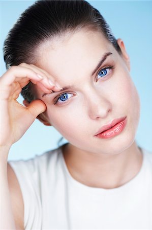 simsearch:6108-05855659,k - Portrait of young woman, hand on forehead Stock Photo - Premium Royalty-Free, Code: 6108-05873653