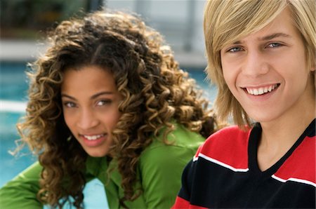 Portrait of a teenage boy smiling with a girl Stock Photo - Premium Royalty-Free, Code: 6108-05873683