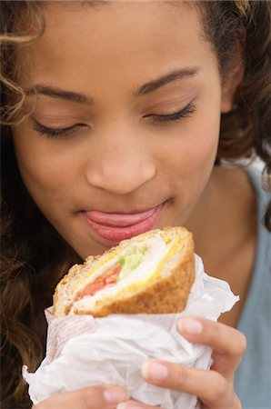 paper napkin - Close-up of a girl eating a sandwich Stock Photo - Premium Royalty-Free, Code: 6108-05873695