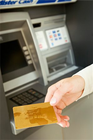 person at vending machine - Close-up of a person's hand holding a credit card Stock Photo - Premium Royalty-Free, Code: 6108-05873604