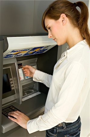 Side profile of a businesswoman using an ATM Fotografie stock - Premium Royalty-Free, Codice: 6108-05873608