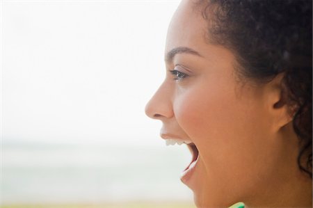 emotional vitality - Close-up of a woman shouting on the beach Stock Photo - Premium Royalty-Free, Code: 6108-05873893