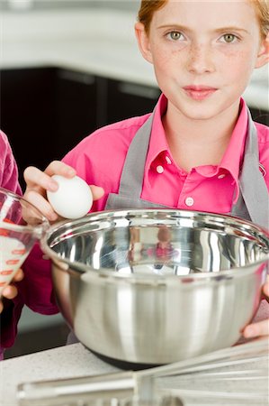 simsearch:6108-05863028,k - Portrait of a girl cooking food in the kitchen Stock Photo - Premium Royalty-Free, Code: 6108-05874098