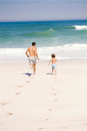 dad not mom child back - Man running with his son on the beach Stock Photo - Premium Royalty-Free, Code: 6108-05874157