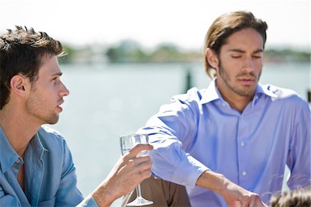 Man enjoying drink with his friend Stock Photo - Premium Royalty-Free, Code: 6108-05874123