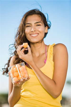 fruit stand boxes - Woman holding a jar of fruits Stock Photo - Premium Royalty-Free, Code: 6108-05874125