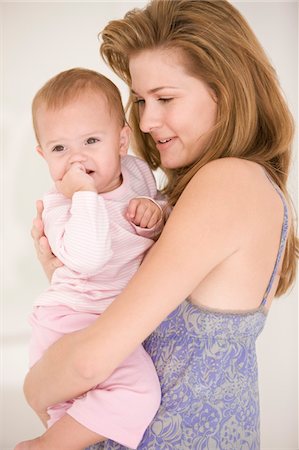 simsearch:6108-05863227,k - Woman carrying her daughter Stock Photo - Premium Royalty-Free, Code: 6108-05874133