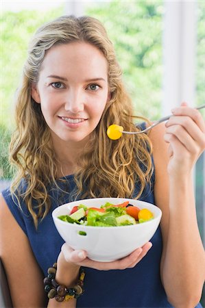 fruit salad - Portrait of a woman eating fruit salad Stock Photo - Premium Royalty-Free, Code: 6108-05874137
