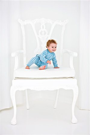 Baby boy sitting in an armchair Stock Photo - Premium Royalty-Free, Code: 6108-05874136
