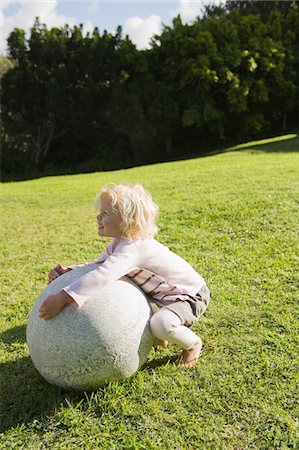 simsearch:6108-05874136,k - Girl playing with a round stone Stock Photo - Premium Royalty-Free, Code: 6108-05874349