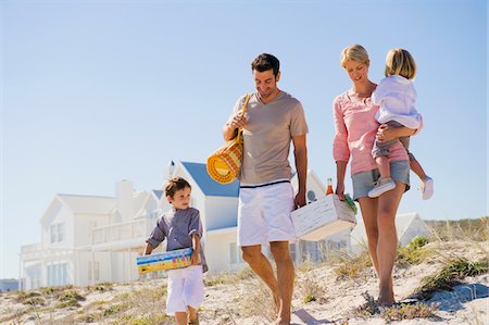 family walk sand - Family on vacations on the beach Stock Photo - Premium Royalty-Free, Code: 6108-05874372