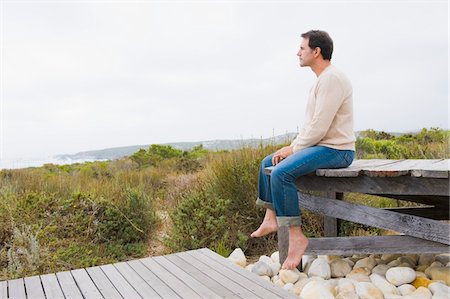 simsearch:6108-05874310,k - Man sitting on a boardwalk and thinking Stock Photo - Premium Royalty-Free, Code: 6108-05874309