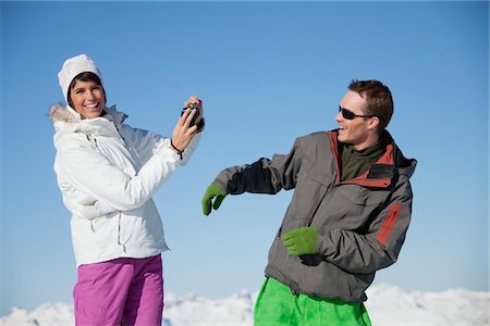 simsearch:6108-05866928,k - Young woman in ski wear taking a photo of her boyfriend Stock Photo - Premium Royalty-Free, Code: 6108-05874589