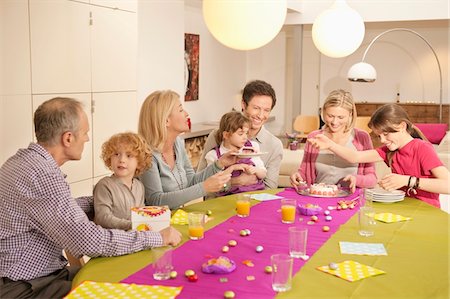 someone cutting cake - Family at a birthday celebration Stock Photo - Premium Royalty-Free, Code: 6108-05874658