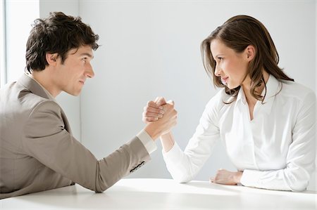 Businessman arm wrestling with a businesswoman Stock Photo - Premium Royalty-Free, Code: 6108-05874687