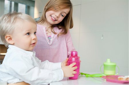 Girl smiling with her brother Stock Photo - Premium Royalty-Free, Code: 6108-05874614