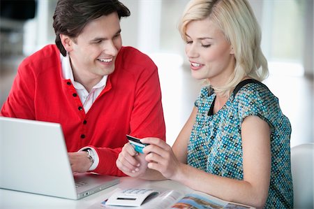 Couple shopping online with a laptop Stock Photo - Premium Royalty-Free, Code: 6108-05874773