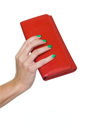 Close-up of woman's hand holding red purse Stock Photo - Premium Royalty-Free, Code: 6108-05874883