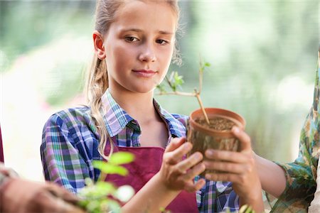 simsearch:6108-05872602,k - Girl holding a potted plant Stock Photo - Premium Royalty-Free, Code: 6108-05874947