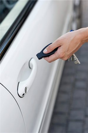 Person's hand unlocking the car with remote control Stock Photo - Premium Royalty-Free, Code: 6108-05874919