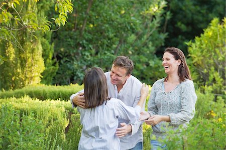 senior parent and son and adults only - Mature couple hugging their mother in a garden Stock Photo - Premium Royalty-Free, Code: 6108-05875054