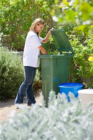 recycling women - Woman looking into recycling bin Stock Photo - Premium Royalty-Free, Code: 6108-05875018