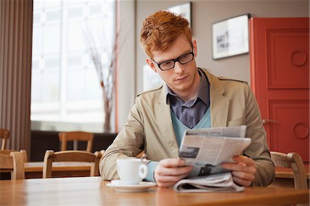 simsearch:6108-06166066,k - Man sitting in a restaurant and reading a newspaper Stock Photo - Premium Royalty-Free, Code: 6108-06166066