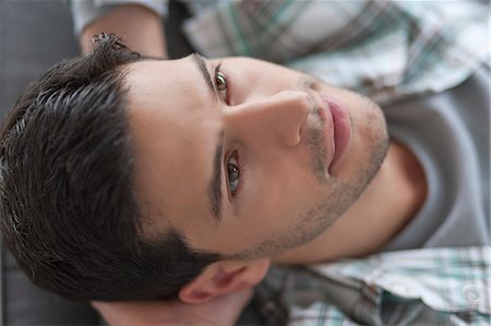 stubble - Man lying on a couch and thinking Stock Photo - Premium Royalty-Free, Code: 6108-06166009