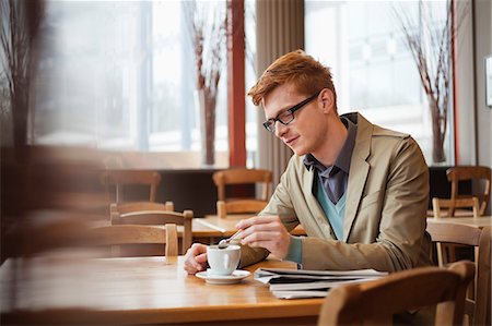 eyeglasses and newspaper - Man drinking tea in a restaurant Stock Photo - Premium Royalty-Free, Code: 6108-06166027