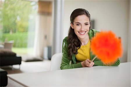 simsearch:6108-06167873,k - Happy woman holding a feather duster Stock Photo - Premium Royalty-Free, Code: 6108-06166165