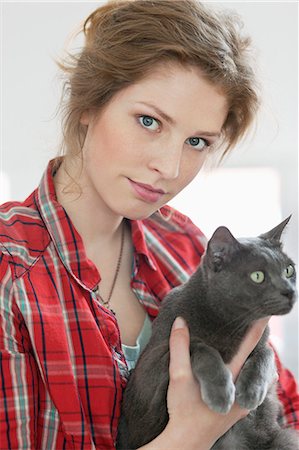 Woman holding a black cat Fotografie stock - Premium Royalty-Free, Codice: 6108-06166182