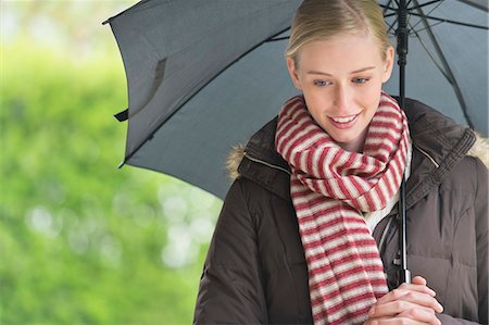 padded jacket - Close-up of a woman with an umbrella Stock Photo - Premium Royalty-Free, Code: 6108-06166104