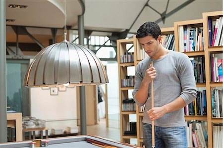 pool, indoor - Man looking at a pool table Stock Photo - Premium Royalty-Free, Code: 6108-06166323