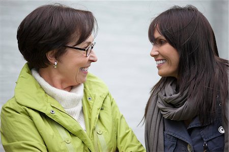 smiling senior people talking family - Two women talking to each other Stock Photo - Premium Royalty-Free, Code: 6108-06166328