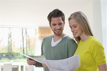 people looking at blueprints - Couple choosing color for their house from a color chart Stock Photo - Premium Royalty-Free, Code: 6108-06166478