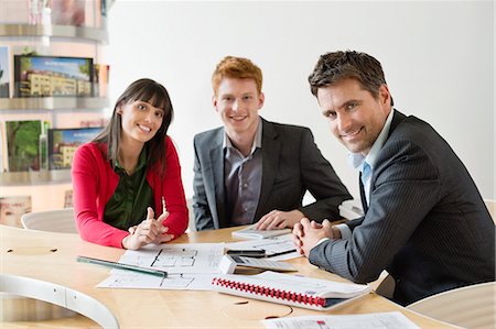 Real estate agent discussing property documents to his clients Stock Photo - Premium Royalty-Free, Code: 6108-06166564