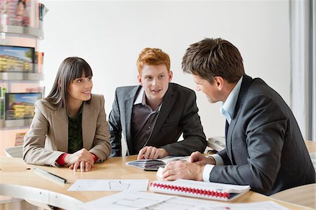 Real estate agent discussing property documents to his clients Fotografie stock - Premium Royalty-Free, Codice: 6108-06166570