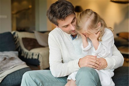 Man holding his cute daughter covering her eyes with hands Stock Photo - Premium Royalty-Free, Code: 6108-06166589