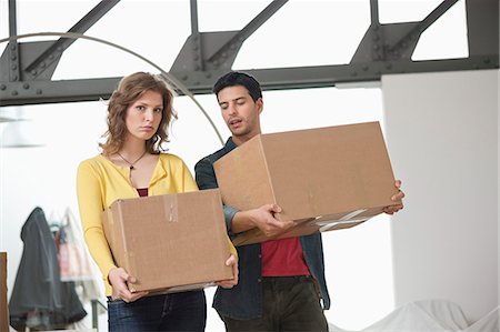 Couple carrying cardboard boxes Stock Photo - Premium Royalty-Free, Code: 6108-06166509