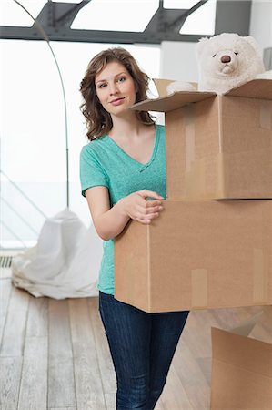 Woman carrying cardboard boxes Stock Photo - Premium Royalty-Free, Code: 6108-06166516