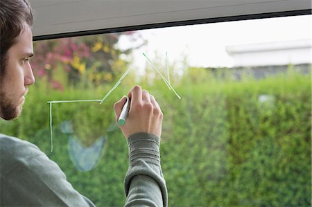 Man drawing an architecture design on the glass of window Foto de stock - Sin royalties Premium, Código: 6108-06166536