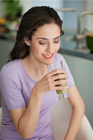 Woman holding a glass of cold soup and smiling Stock Photo - Premium Royalty-Free, Code: 6108-06166645