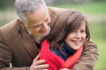 simsearch:6108-06167245,k - Man hugging his daughter in a park Stock Photo - Premium Royalty-Free, Code: 6108-06166625