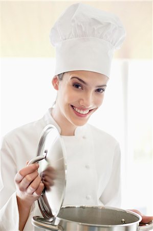 Happy female chef holding a saucepan Stock Photo - Premium Royalty-Free, Code: 6108-06166760