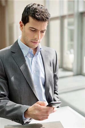 european male - Close-up of a businessman text messaging Stock Photo - Premium Royalty-Free, Code: 6108-06166867