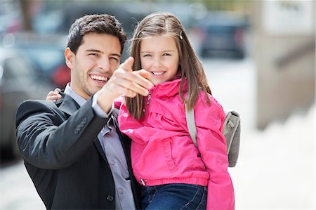 pointing (gesture) - Man carrying his daughter and pointing with finger Stock Photo - Premium Royalty-Free, Code: 6108-06166808