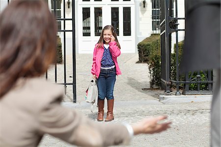 Woman giving warm welcome to her daughter at the school gate Stock Photo - Premium Royalty-Free, Code: 6108-06166810