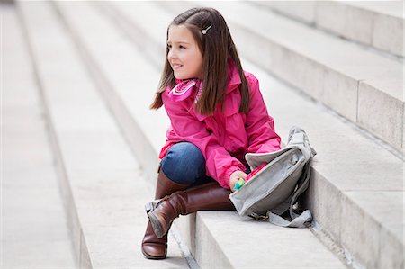 schoolgirl boot child - Girl opening her schoolbag Stock Photo - Premium Royalty-Free, Code: 6108-06166822