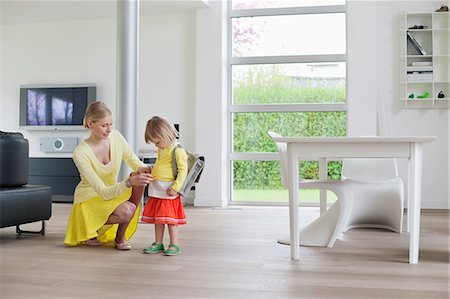 Woman helping her daughter to get ready Stock Photo - Premium Royalty-Free, Code: 6108-06166835